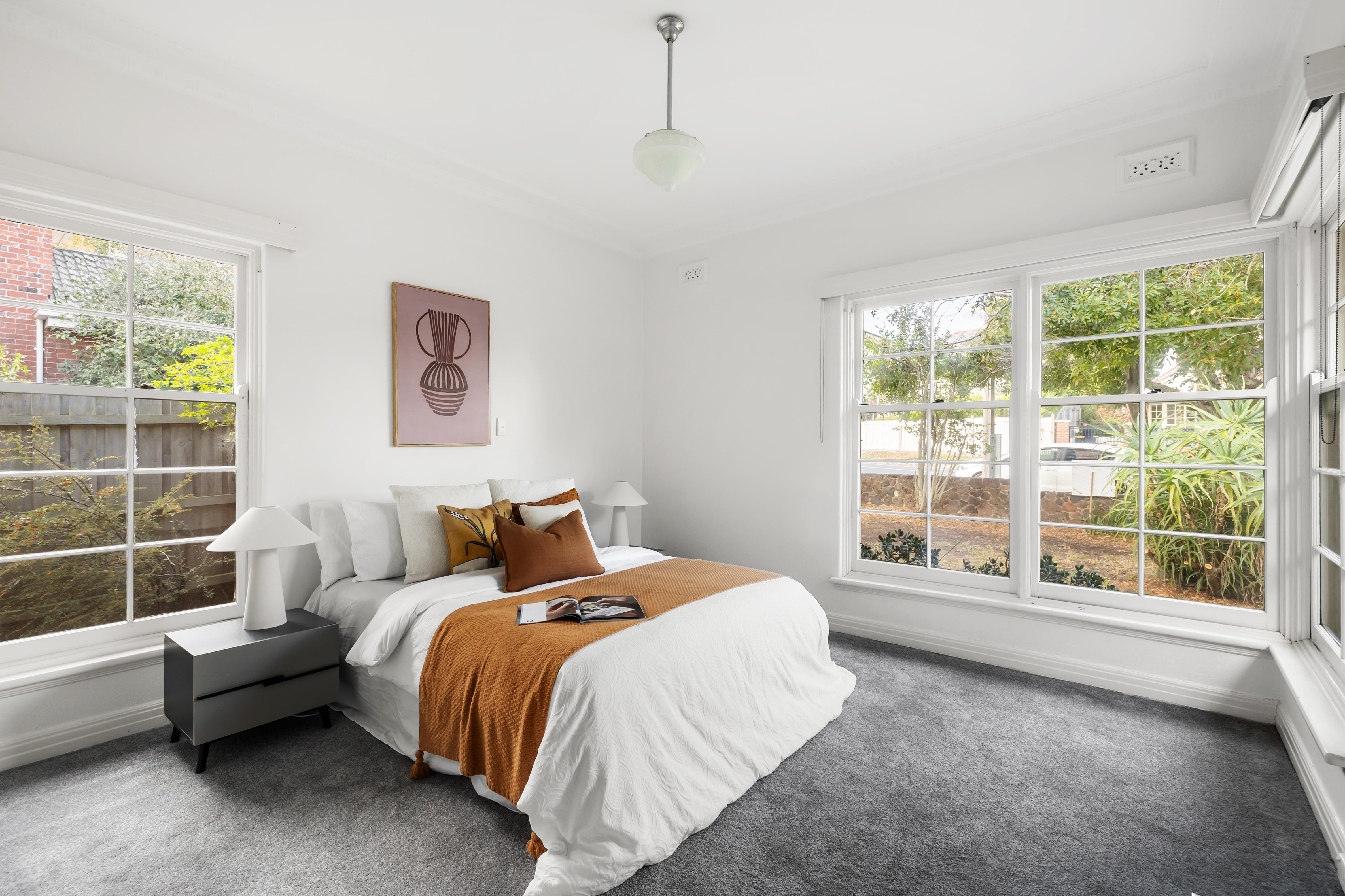 Styled light-filled bedroom with ochre accents
